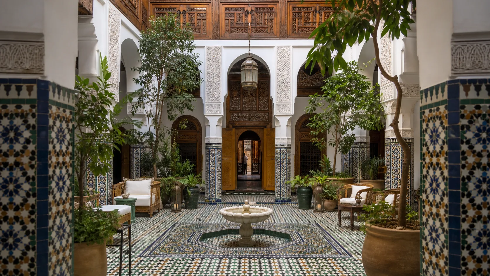 A hidden Marrakech riad — tiled courtyard, fountain and carved cedar